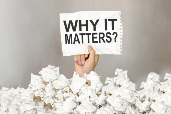 why it matters written on a paper held by a hand in a sea of crumpled papers depicting AFUE rating