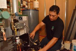 hhc hvac technician servicing heating boiler