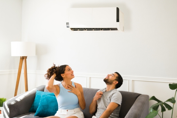couple feeling warm indoors depicting broken AC due to air conditioner condenser rust