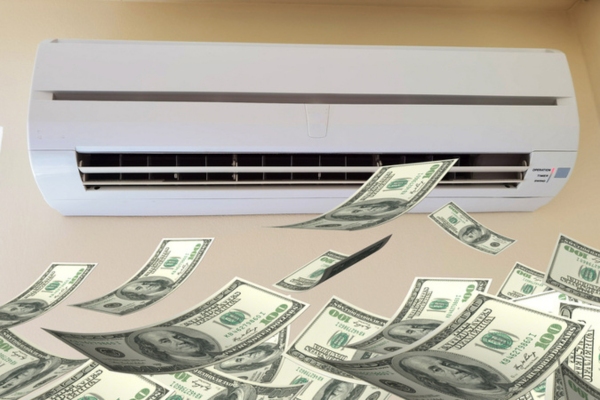 indoor AC unit blowing dollar bills depicting high energy consumption due to air conditioner condenser rust