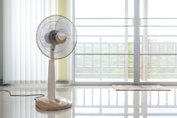 stand fan by the glass door