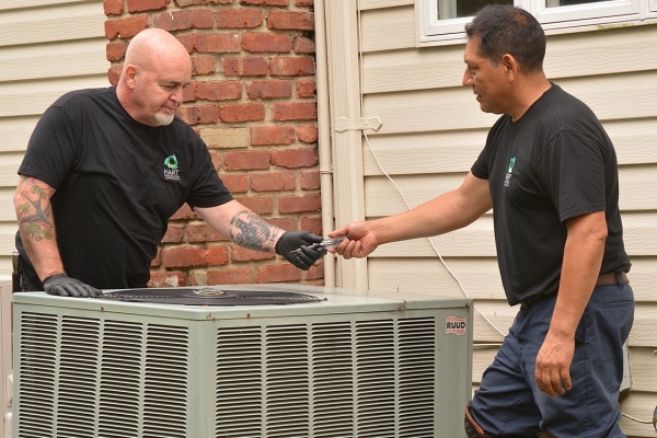 Hart Home Comfort professional technicians attending to residential HVAC system