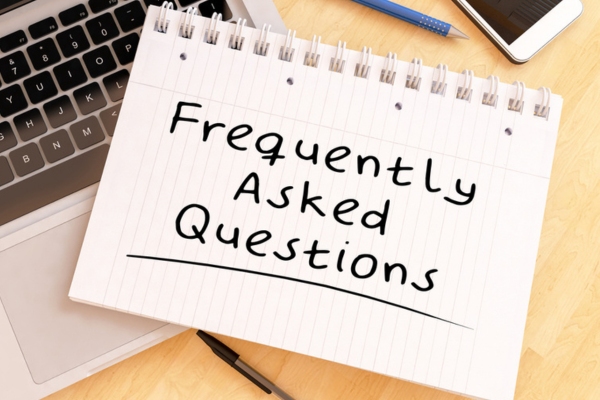 frequently asked questions written on notebook depicting FAQs