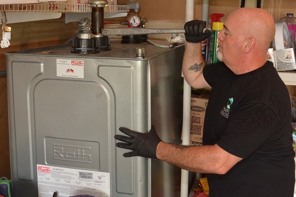 Hart Home Comfort staff tending to Roth Oil Tank