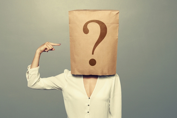 paper bag with question mark on a woman's head depicting FAQs about fuel oil company